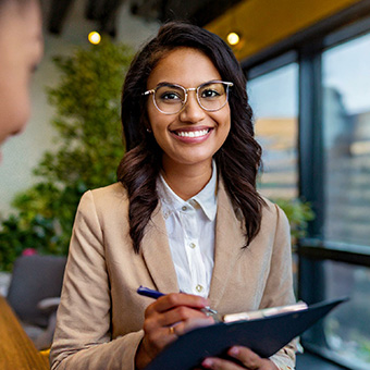 a lady holding a clipboard for an interview